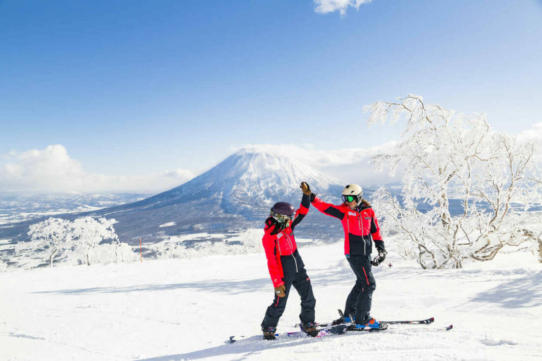 Skiers and snowboarders enjoying the stunning snow in Niseko