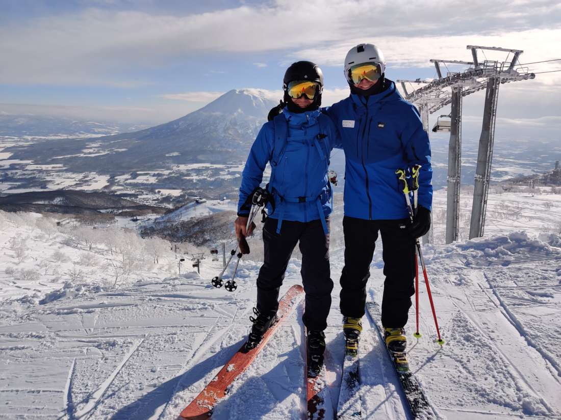 Hokkaido Ski Club ski instructor with guest at the top of the King hooded quad chairlift