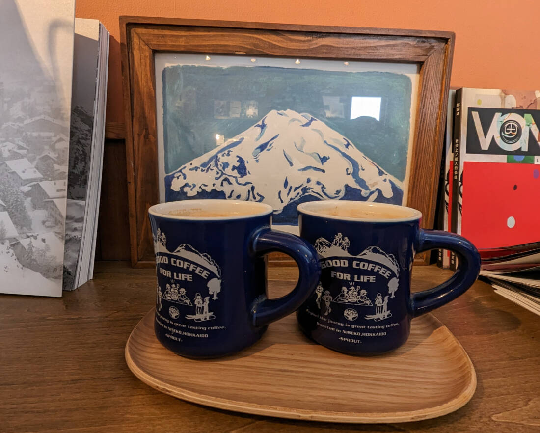 Coffee cups with coffee and Mount Yotei in background