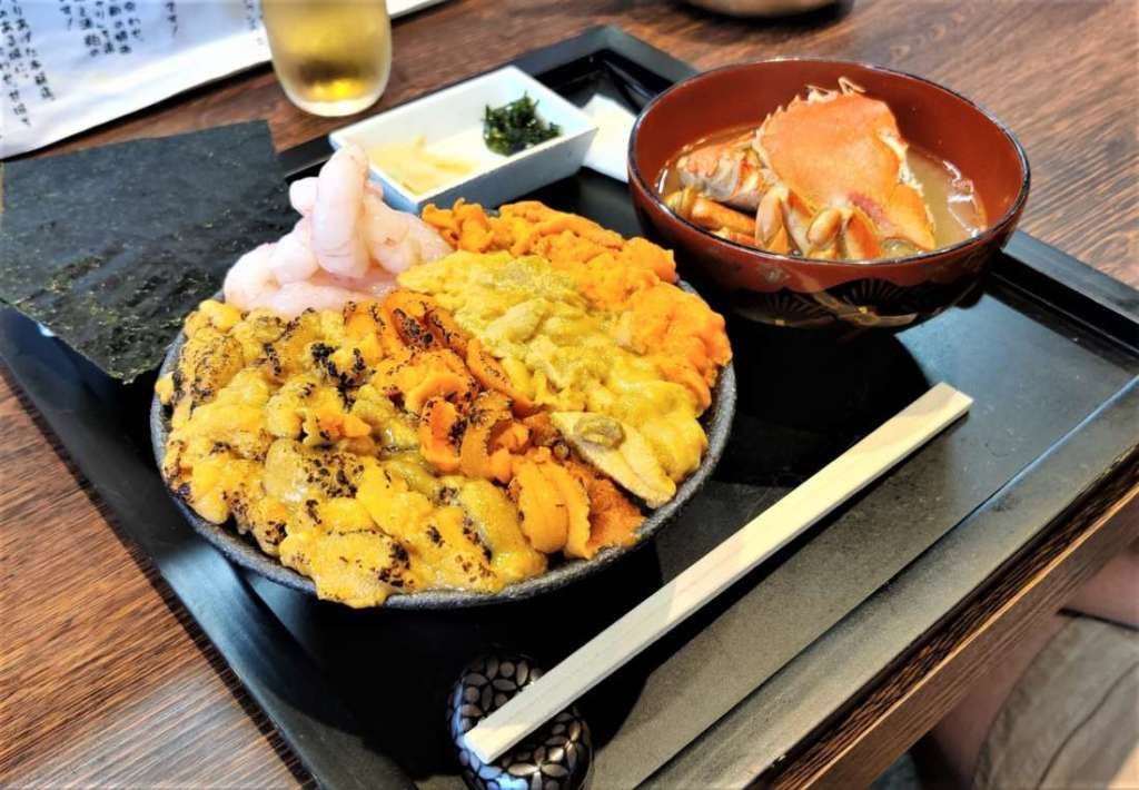 Bowl of fresh uni and snow crab in soup in Niseko area