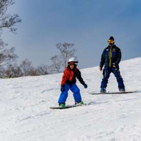 Children’s Private Snowboard Lesson Instructor Adir during snowboard lesson with 7 year old