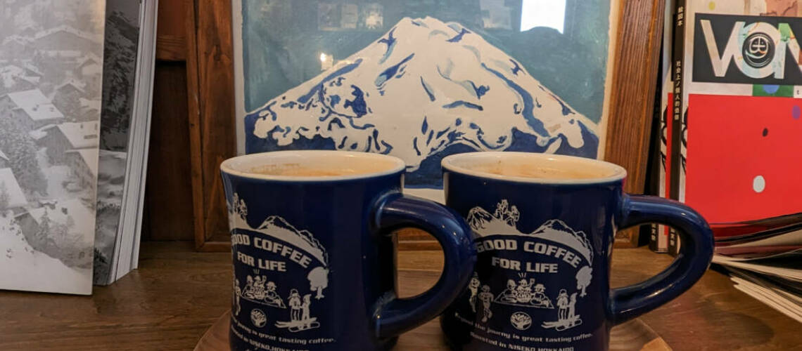 Coffee cups with coffee and Mount Yotei in background
